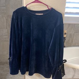 Navy soft top with black ties on arms. This top is classy to dress up or down.